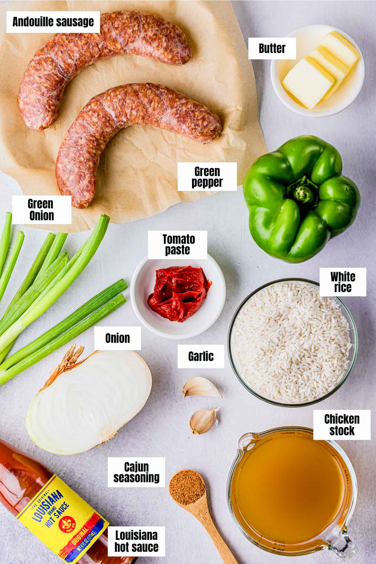 ingredients to make cajun rice on a white board with text labels.