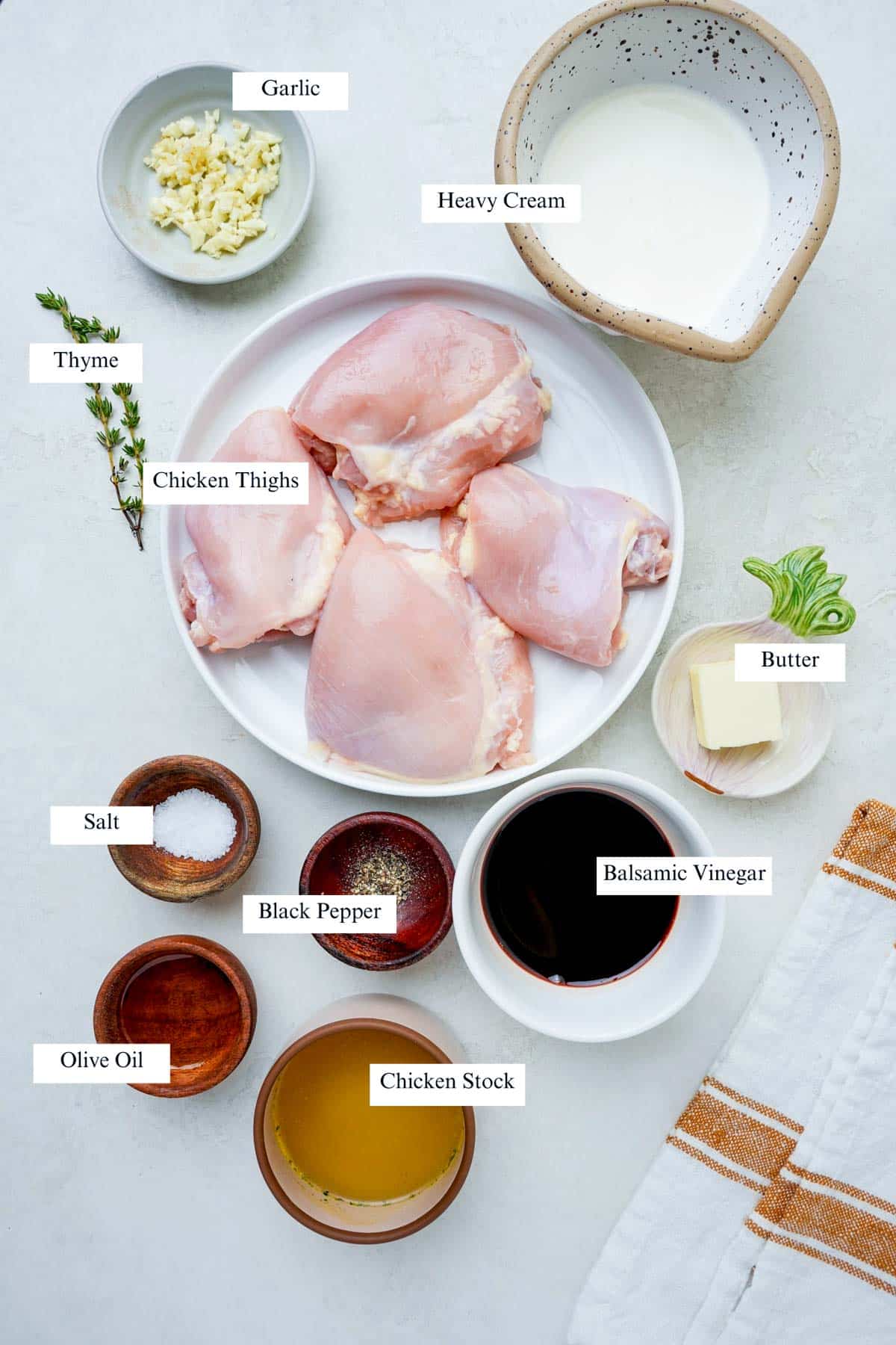 ingredients for sous vide boneless chicken thighs on a white background.