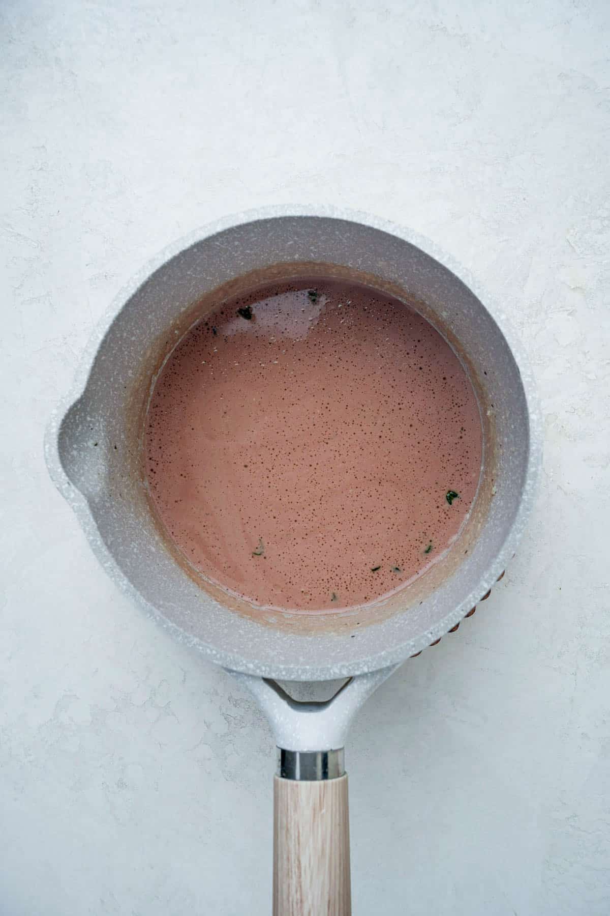 a pink sauce in a saucepan.