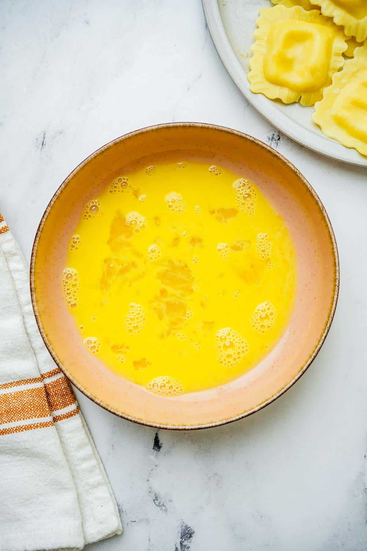 beaten egg in a bowl.