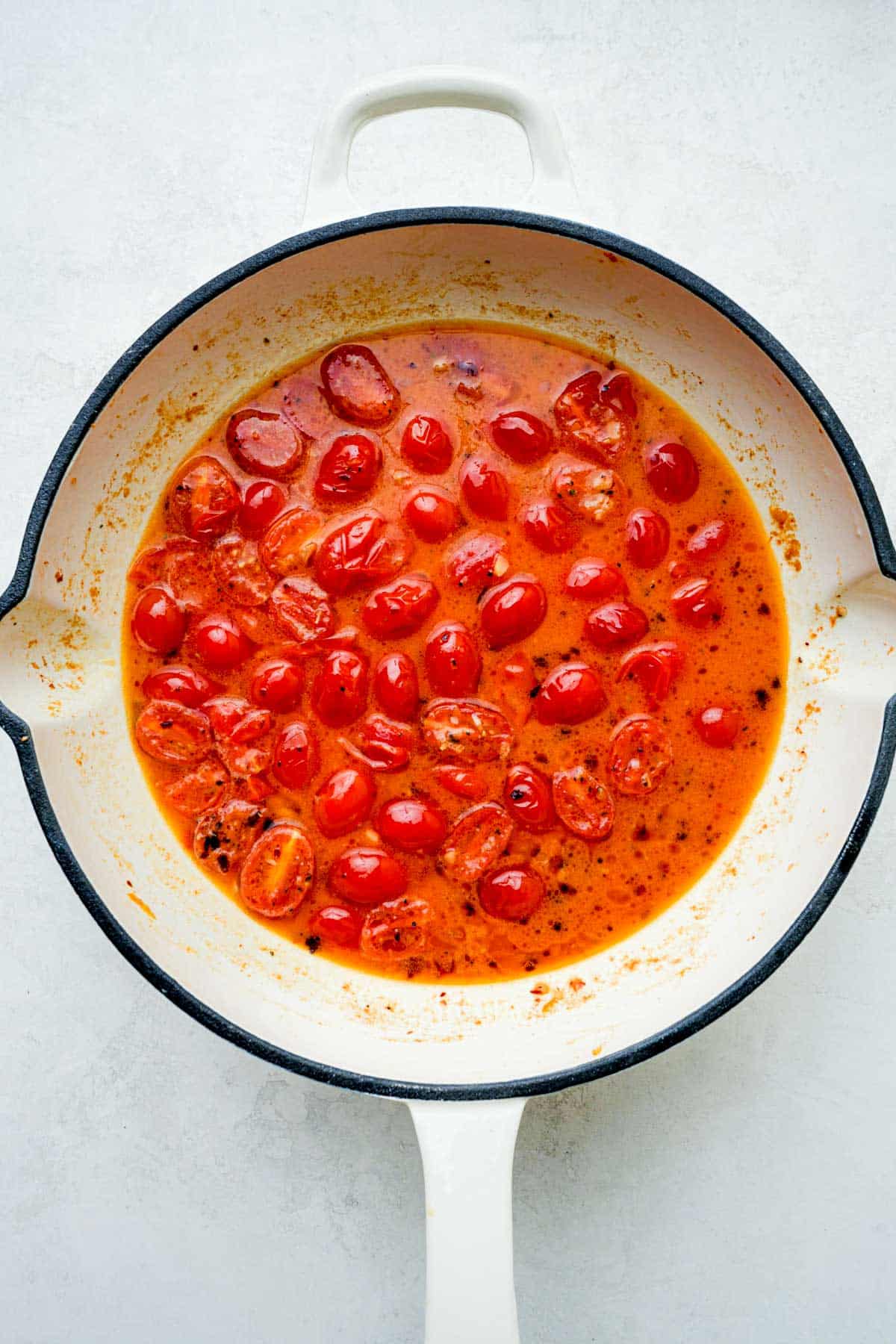 a red tomato sauce cooking in a skillet.