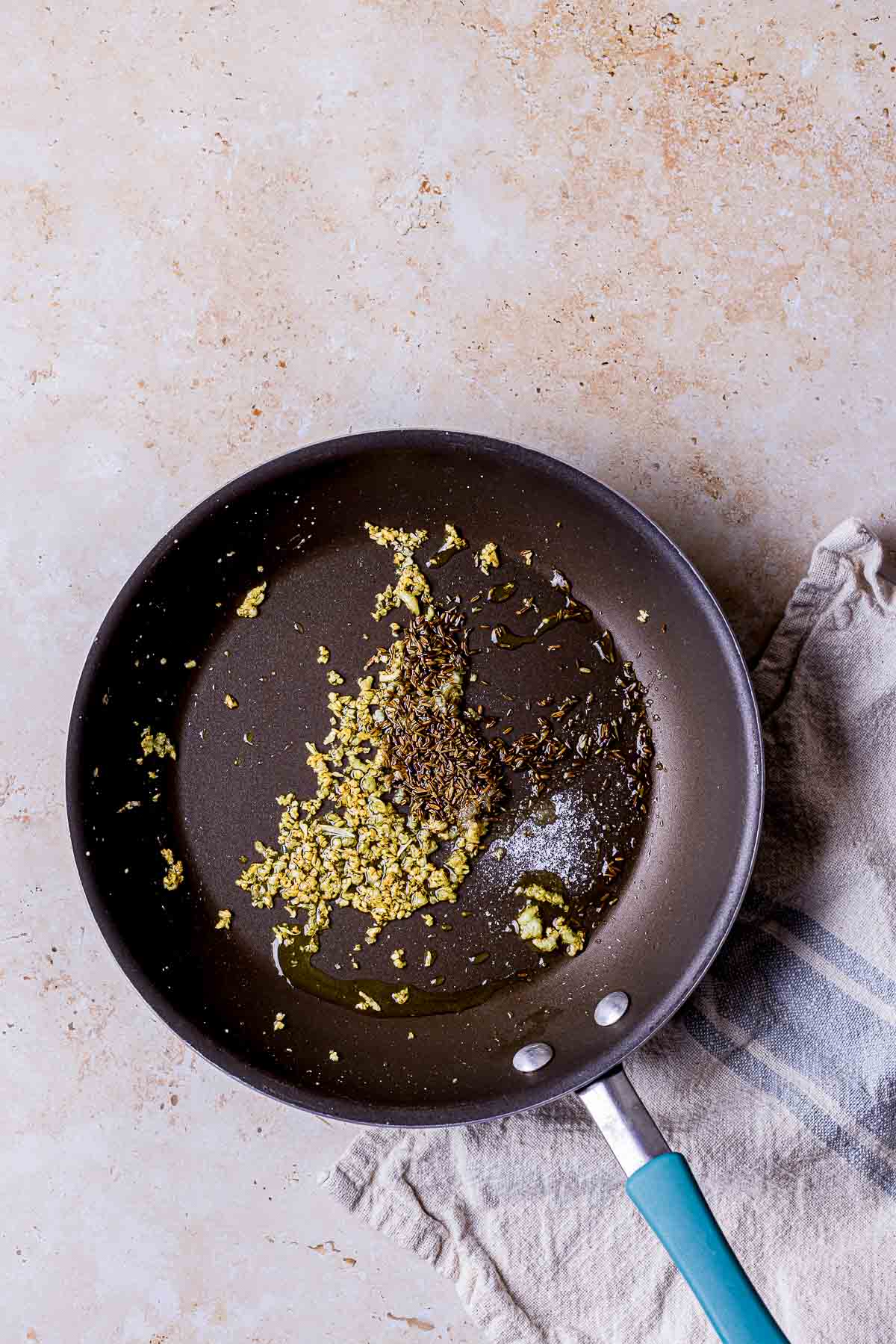 whole spices toasting in a skillet.