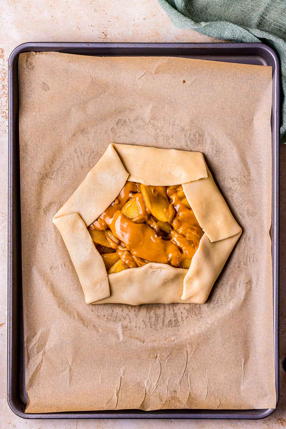 pie crust folded around apples in octagon shape.