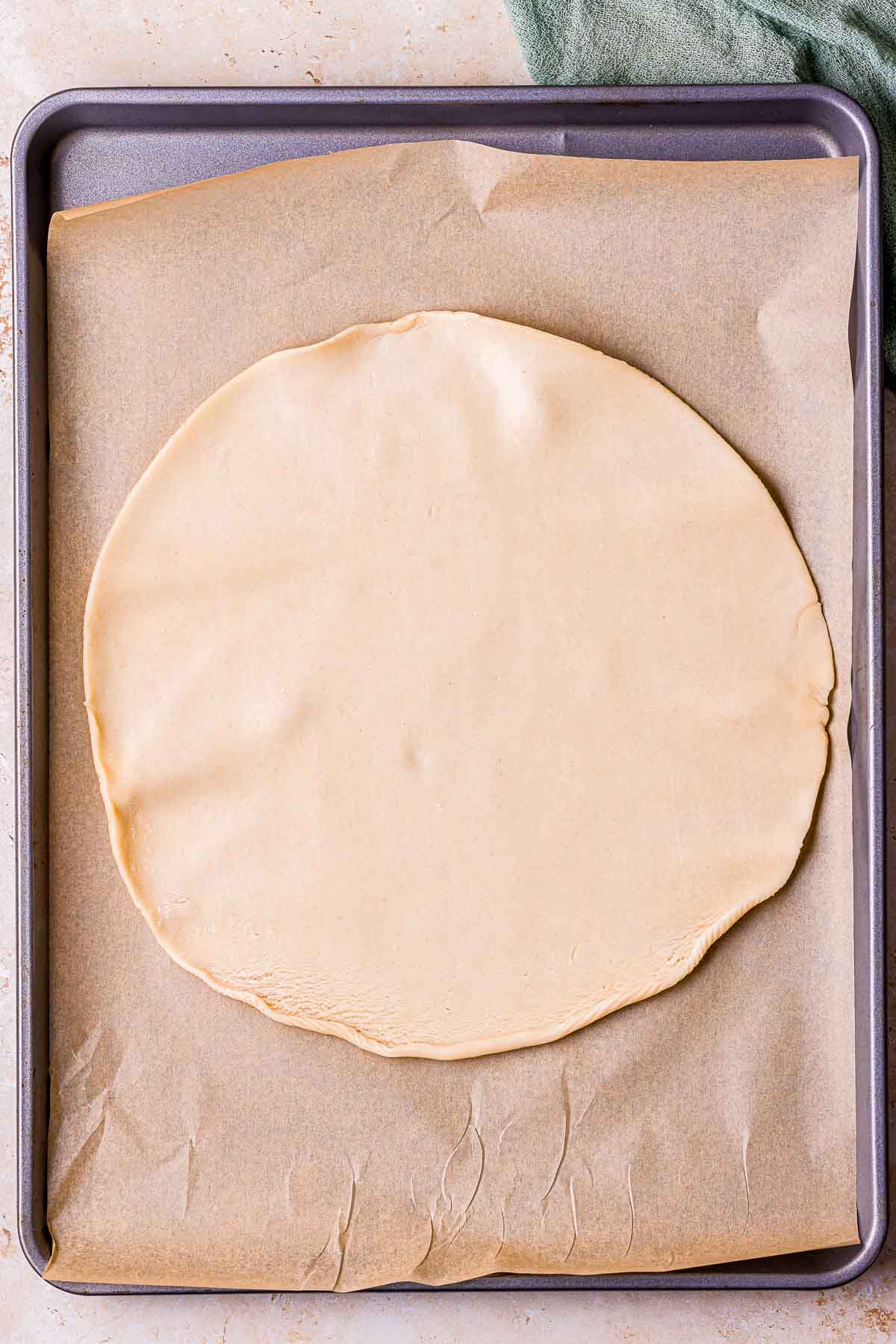 round pie dough on parchment paper.