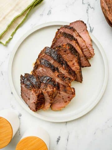 sliced brisket on a white plate.