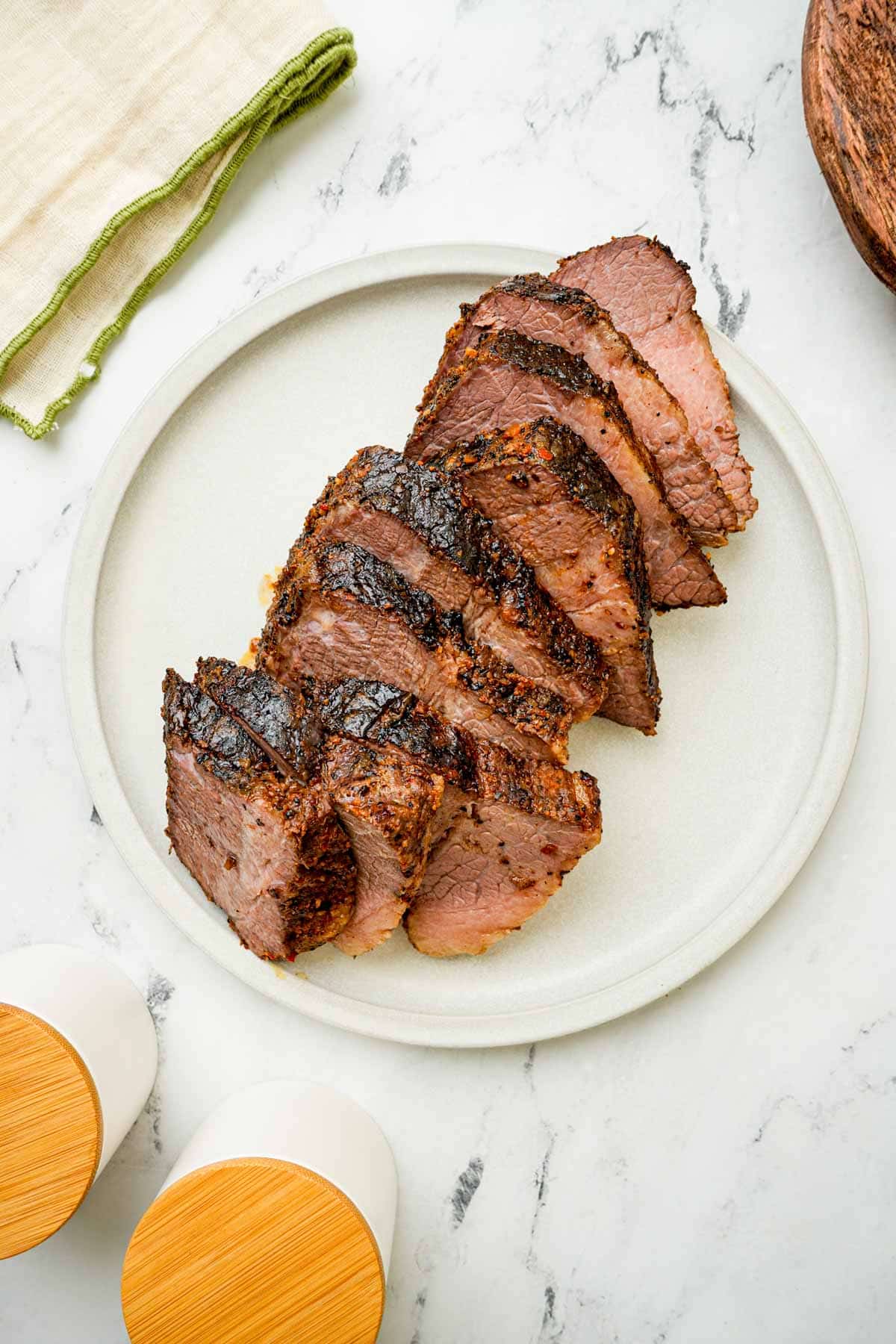 sliced brisket on a white plate.