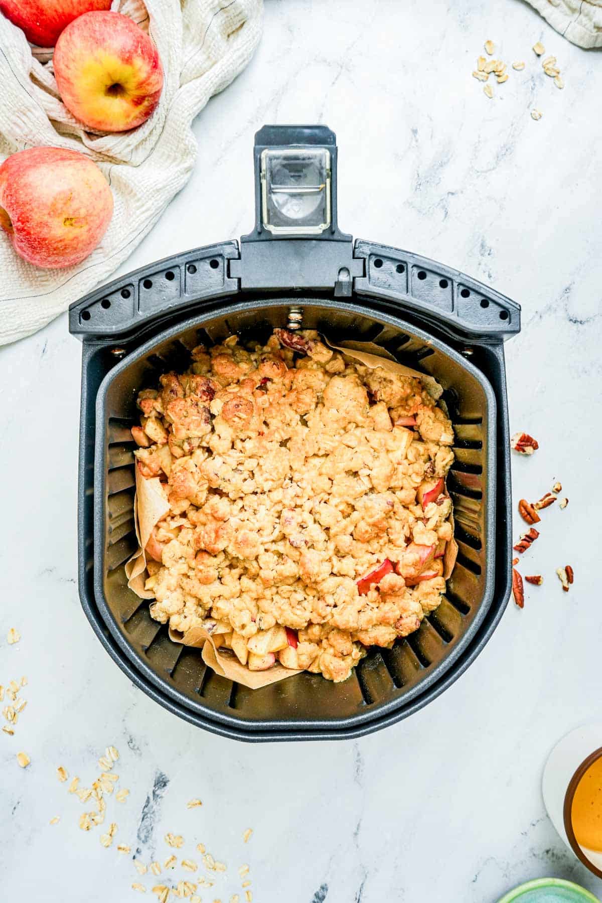 apple crisp cooking in an air fryer.