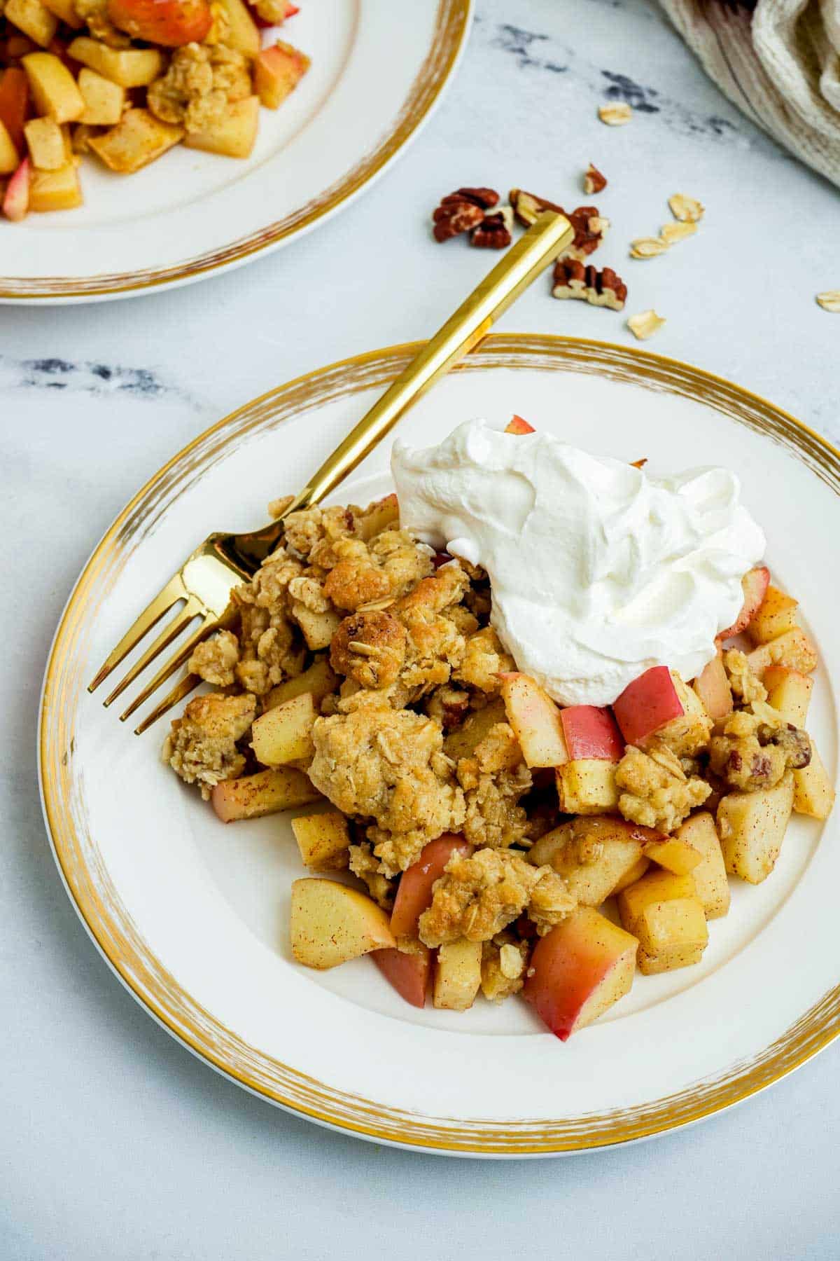 apple dessert and whipped cream on a plate.