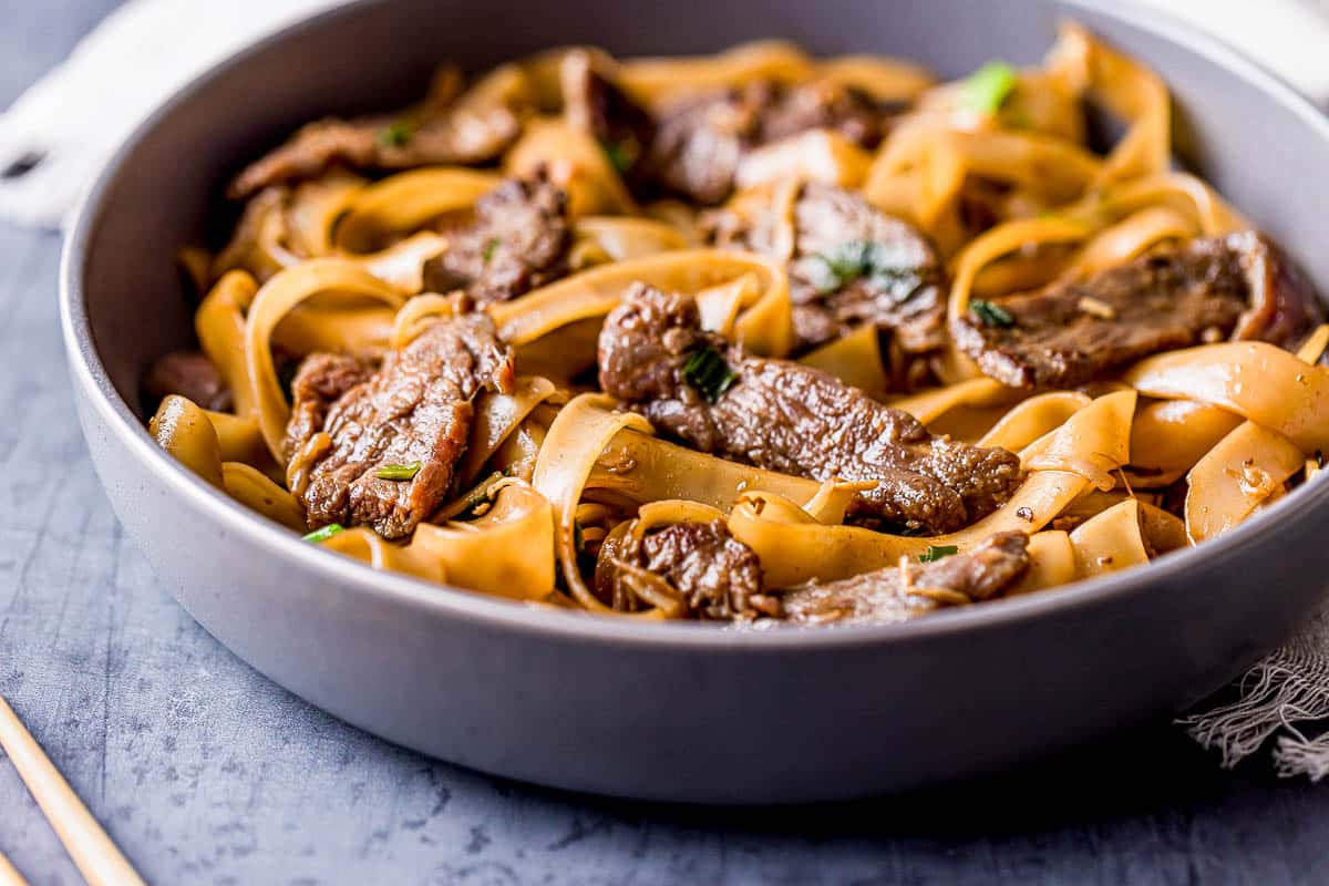 strips of beef with saucy noodles in a bowl.