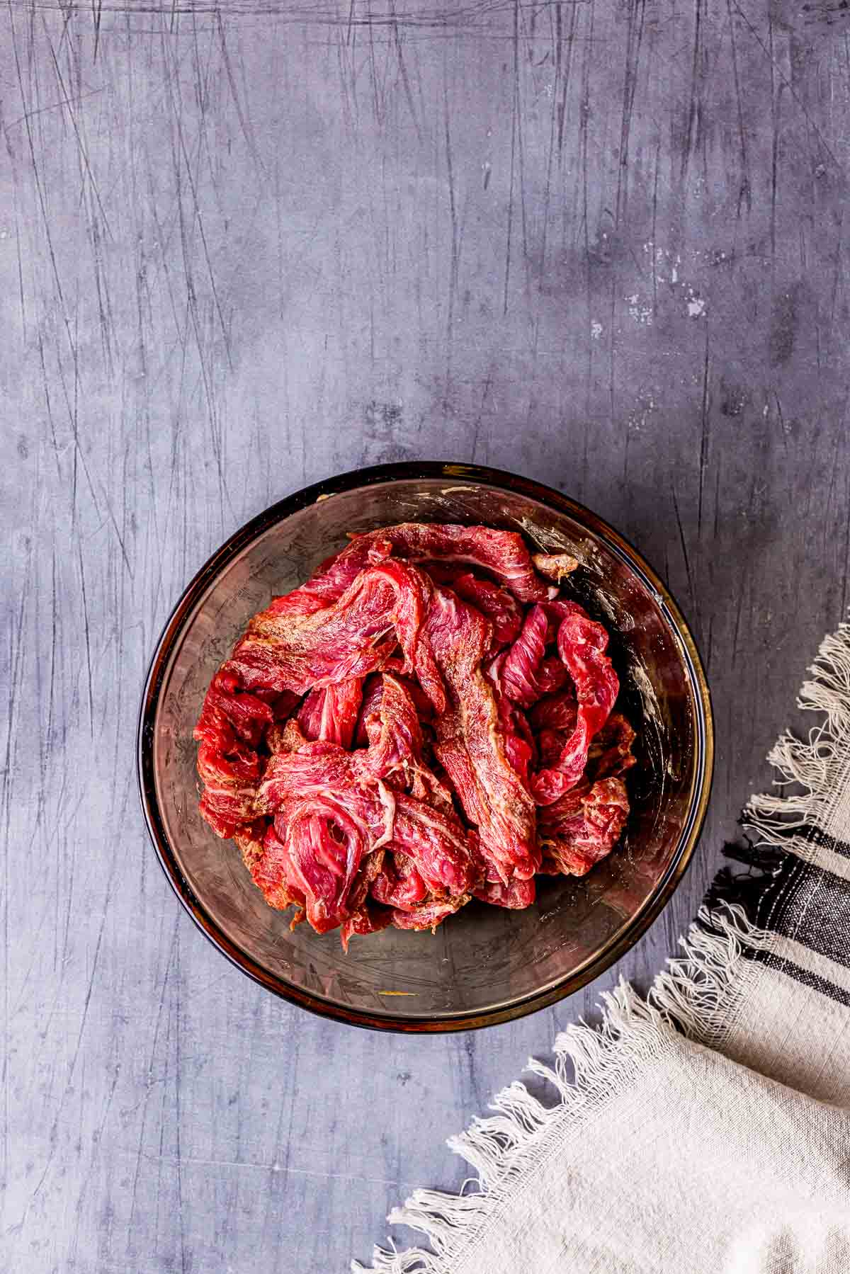 raw beef in a marinade in a bowl.