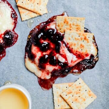 baked brie and cranberry sauce on parchment paper.