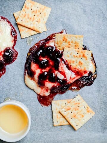 baked brie and cranberry sauce on parchment paper.