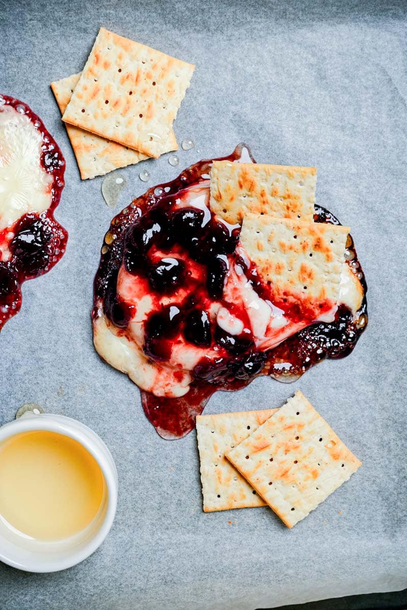 baked brie and cranberry sauce on parchment paper.