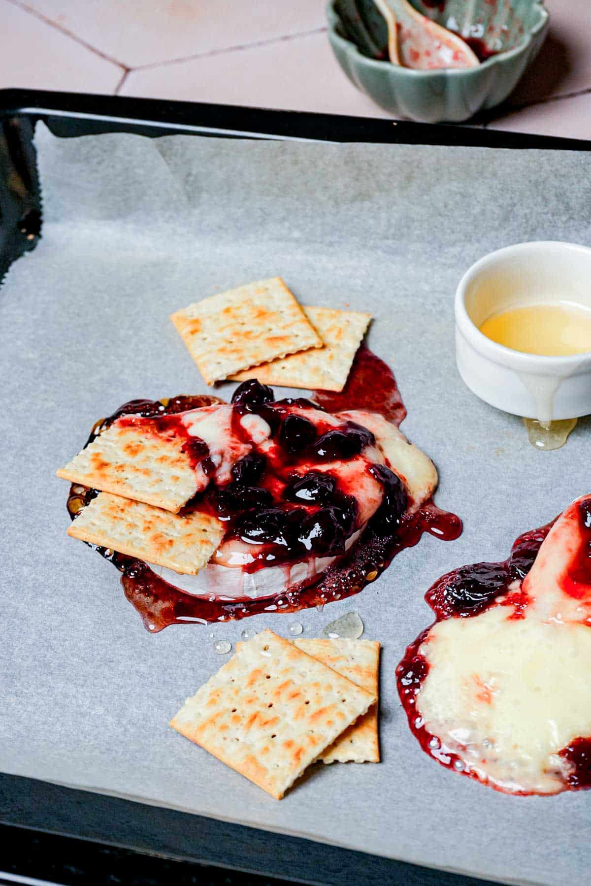 crackers dipped in melted brie and red sauce.