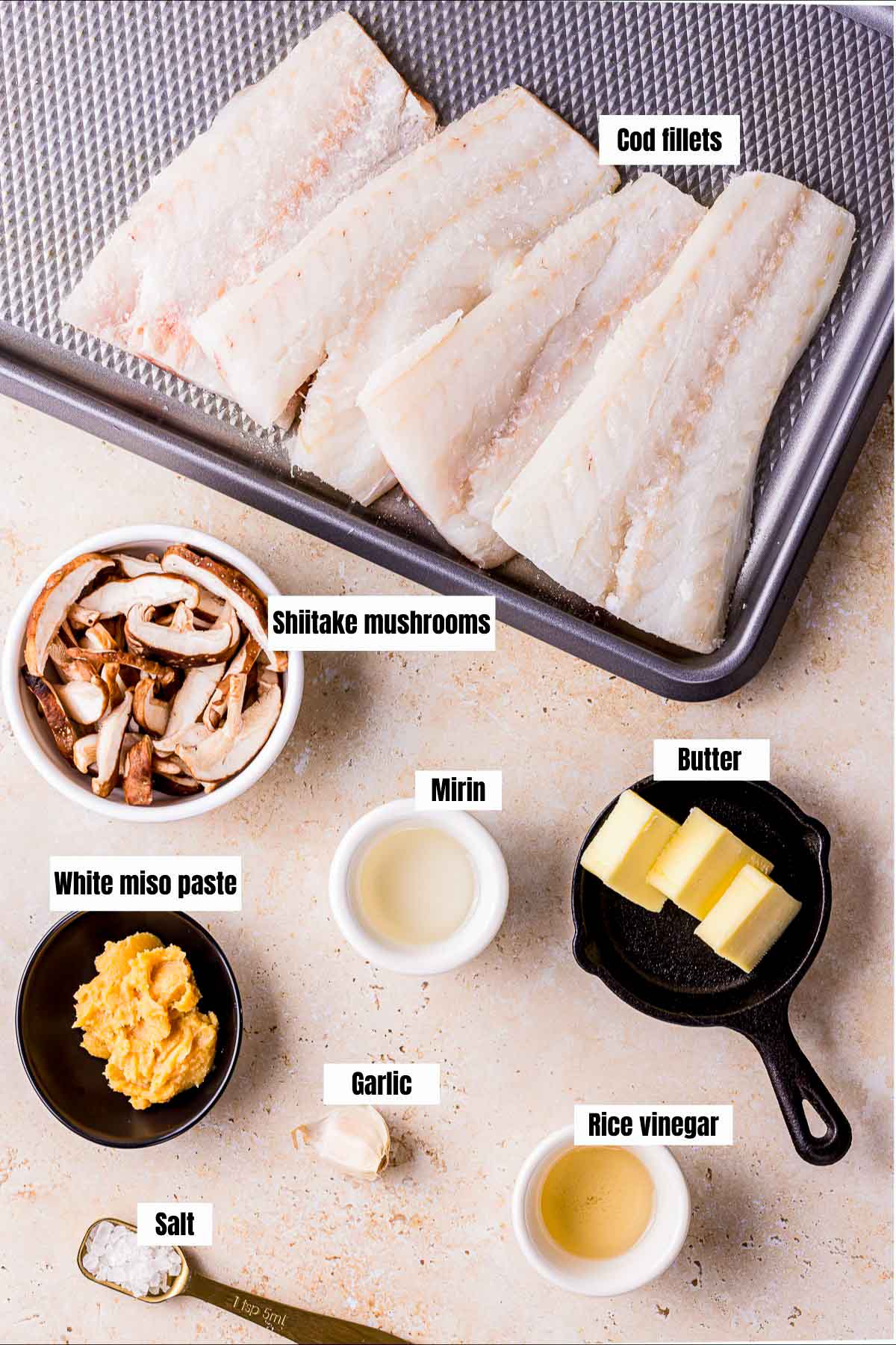 ingredients for sous vide cod on a tan board.