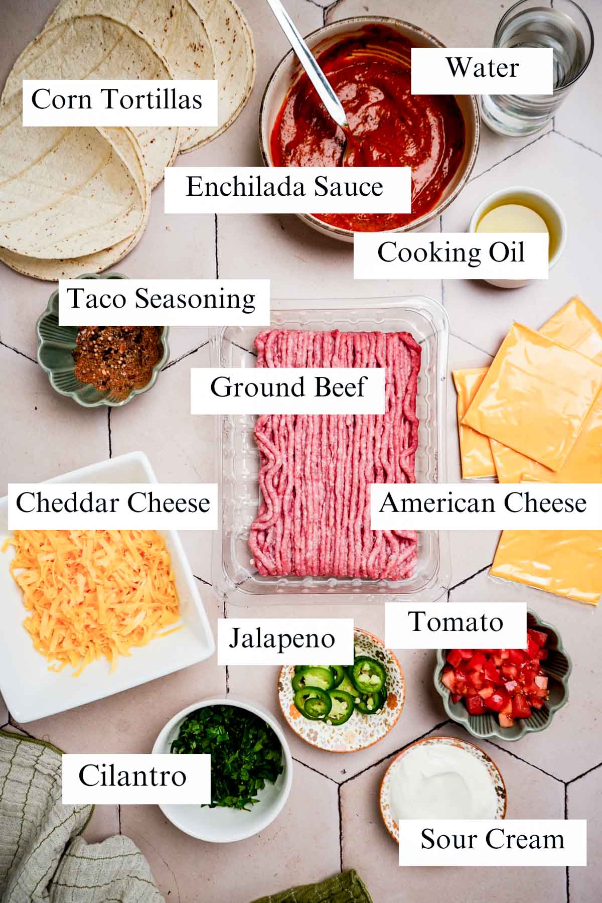 ingredients for tacos with cheese on a white wood board.