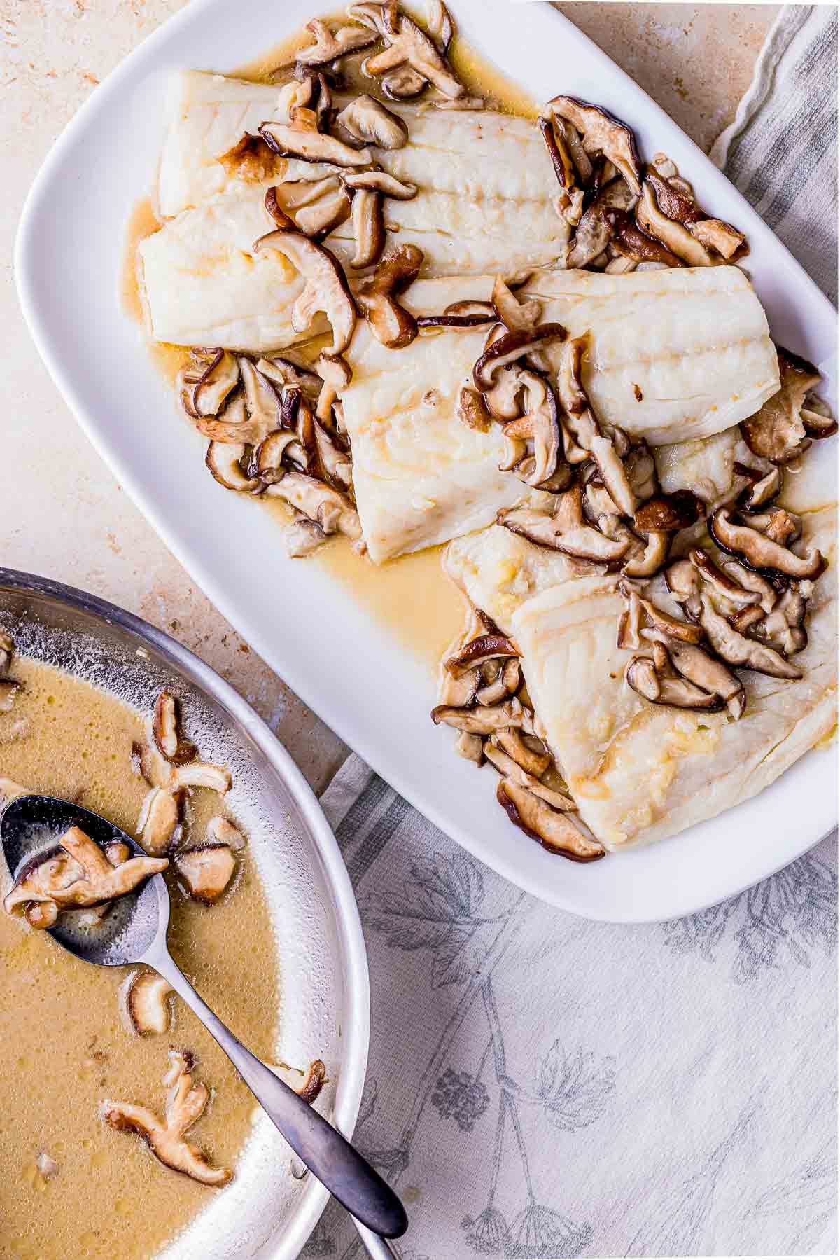 a dish of fish filets with mushrooms sauce.