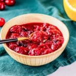 a bowl of cranberry chutney with a spoon.