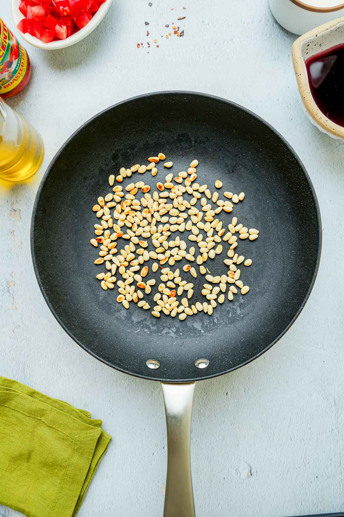 pine nuts toasting in a skillet.