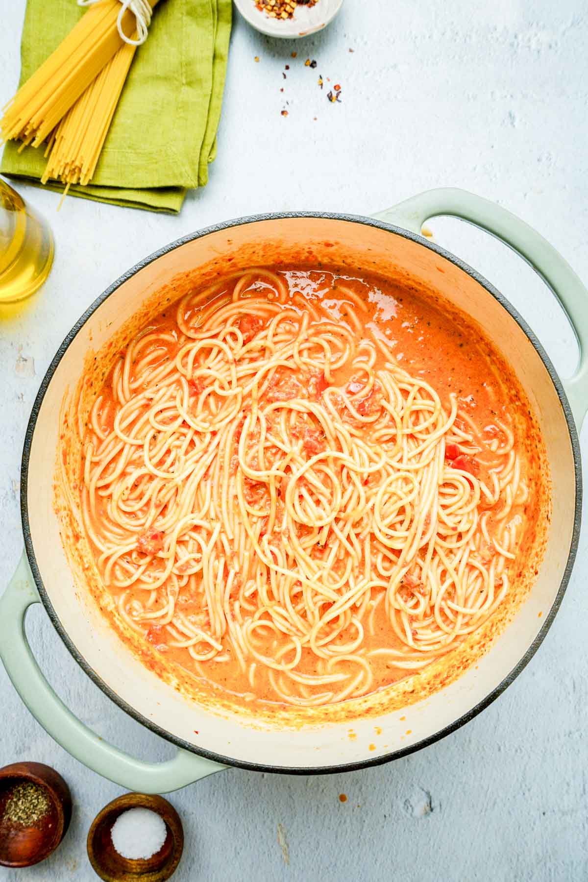 pasta in a red sauce in a pot.