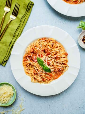 red pesto pasta in a bowl on a table.