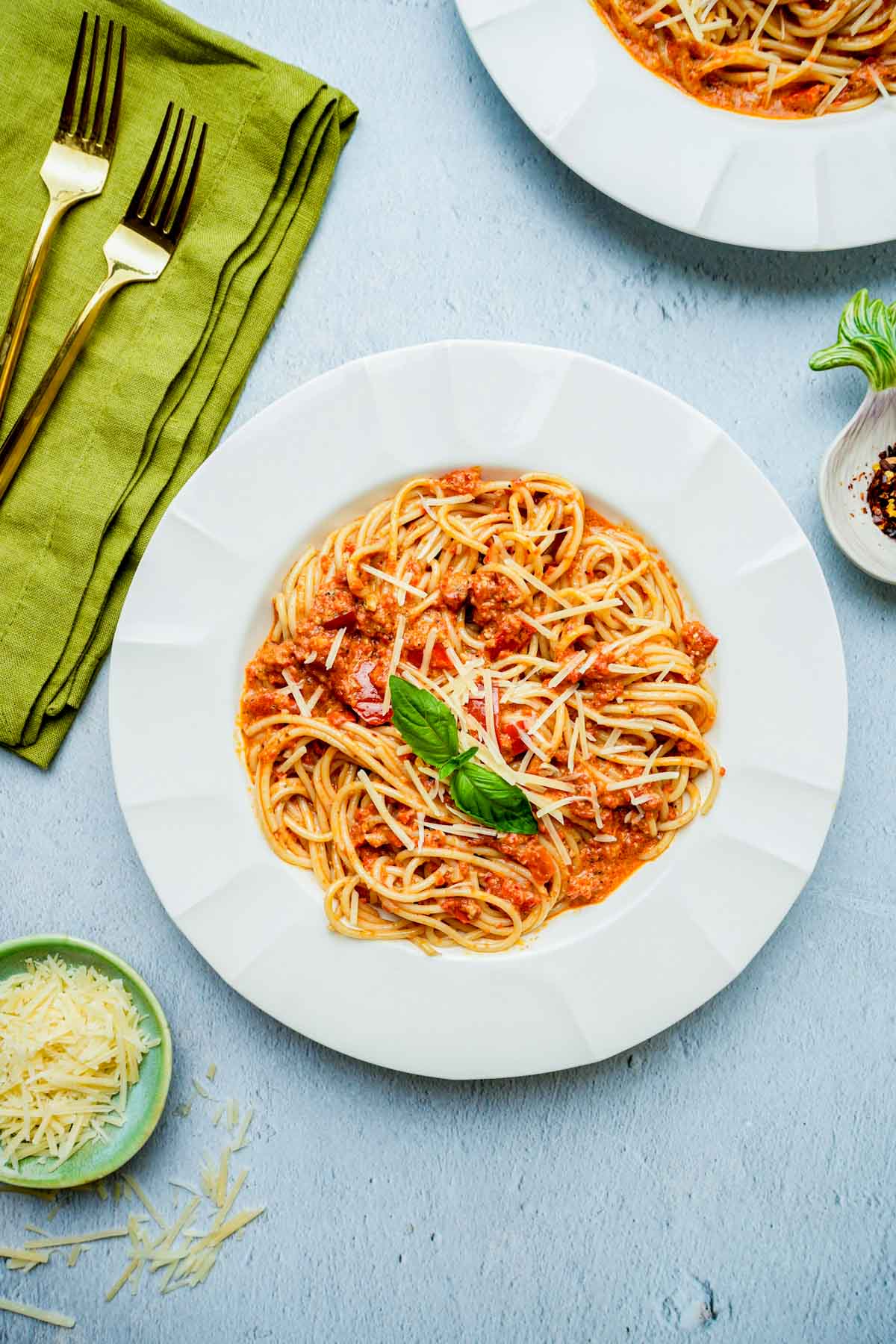 red pesto pasta in a bowl on a table.