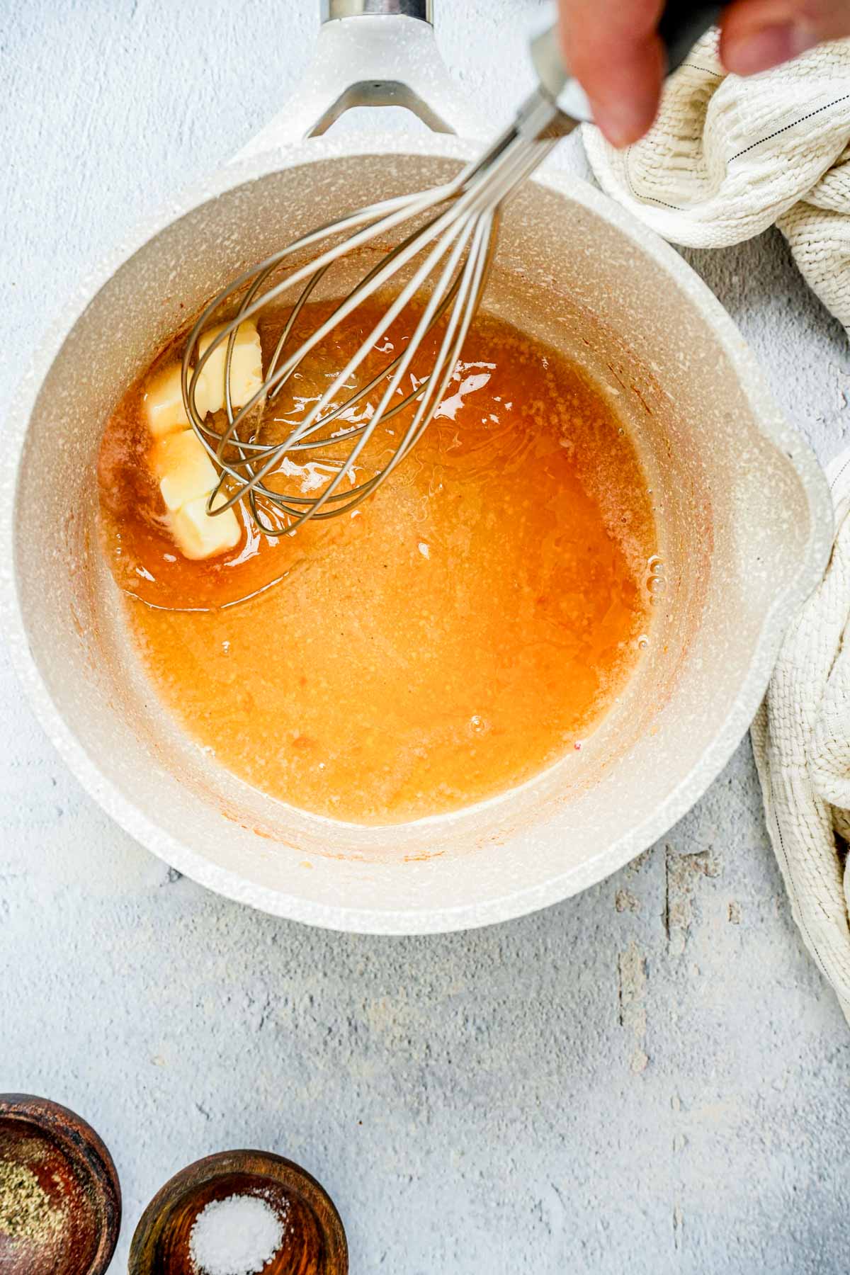 butter being whisked into liquid.