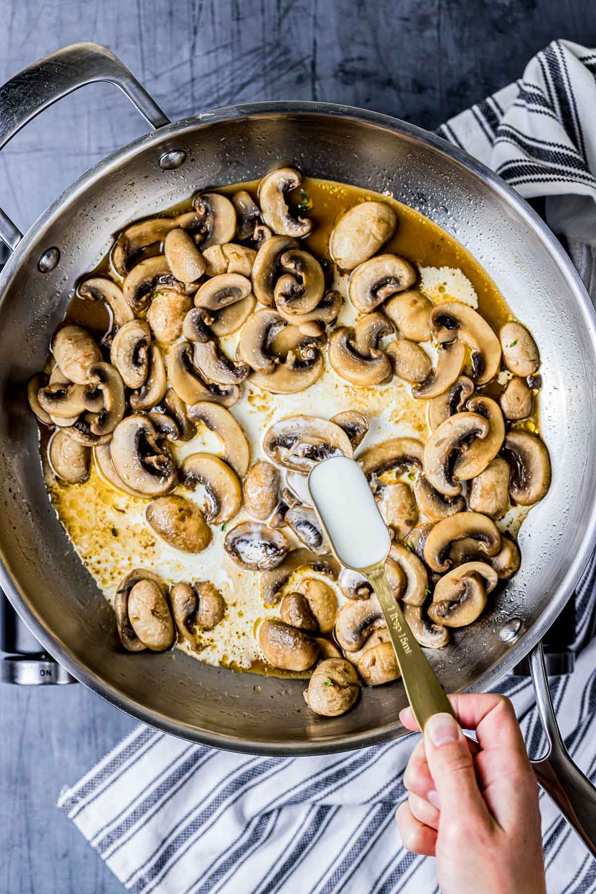 mushrooms in a skillet cooking with cream.