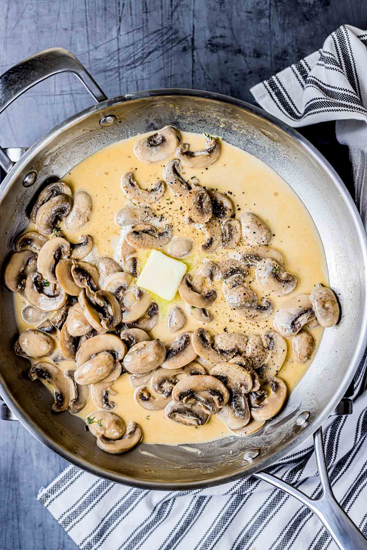 mushrooms in a butter sauce in a skillet.