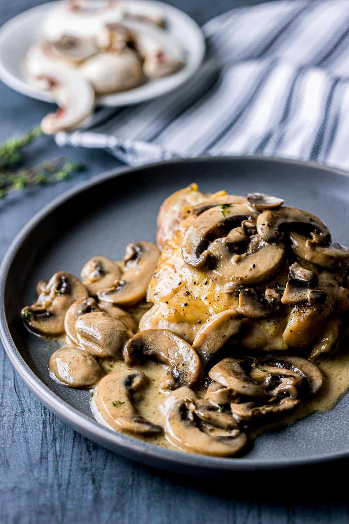 mushrooms sauce poured over chicken thigh.