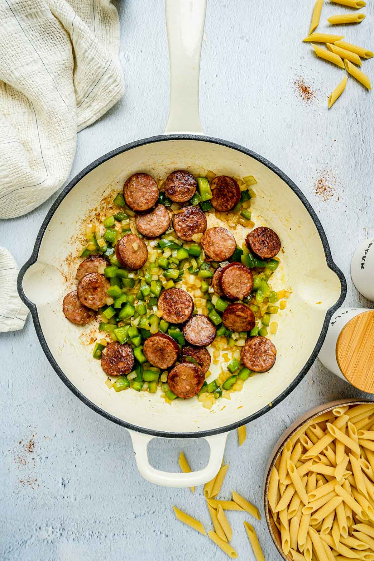 sausage and green peppers in a skillet.