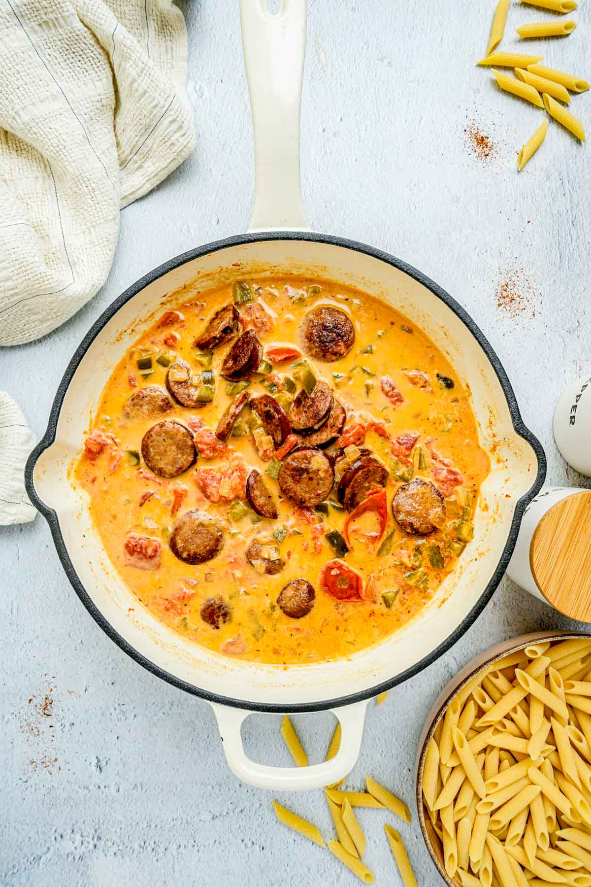 creamy sauce in a pan with sausage.