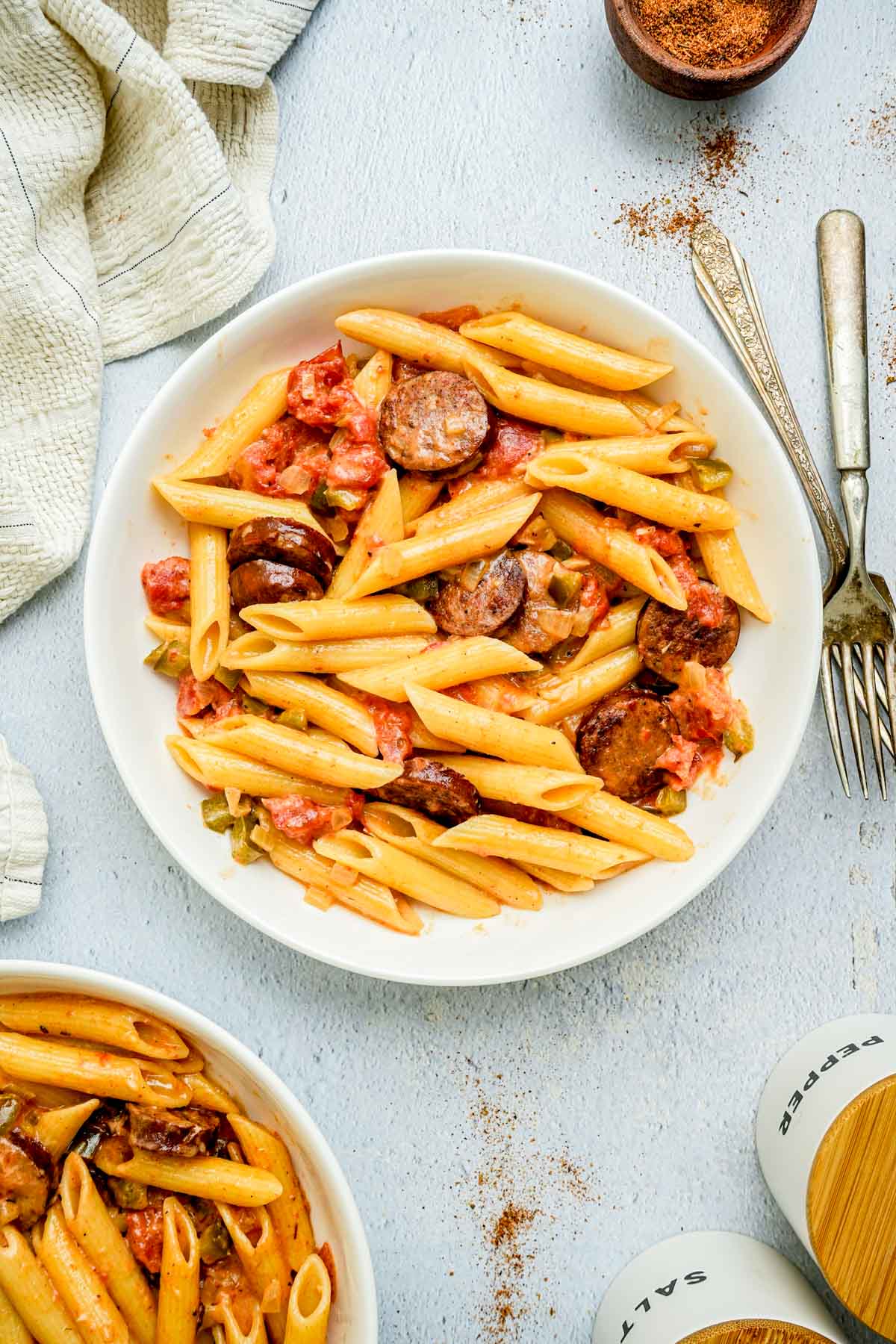 a bowl of creamy cajun pasta and tomatoes.