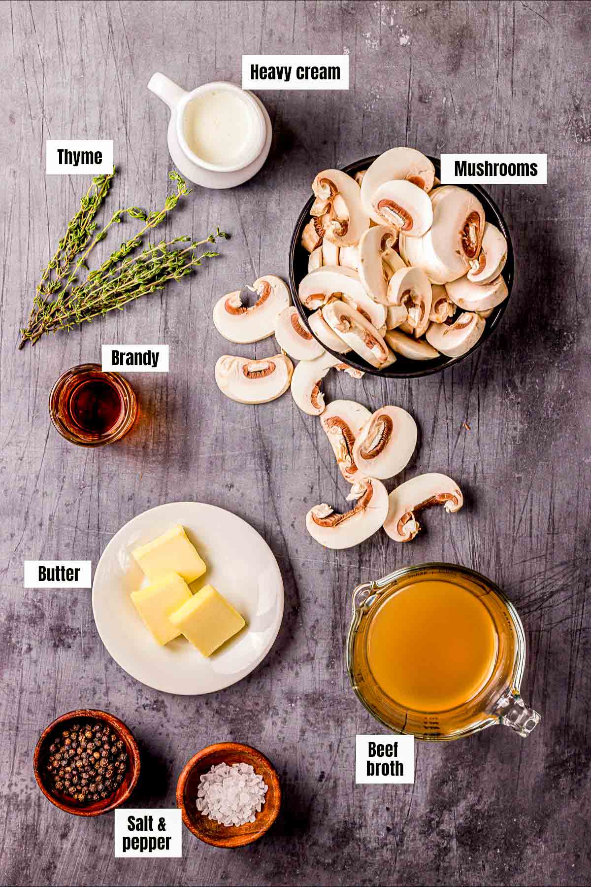 ingredients for brandied mushrooms on a board.