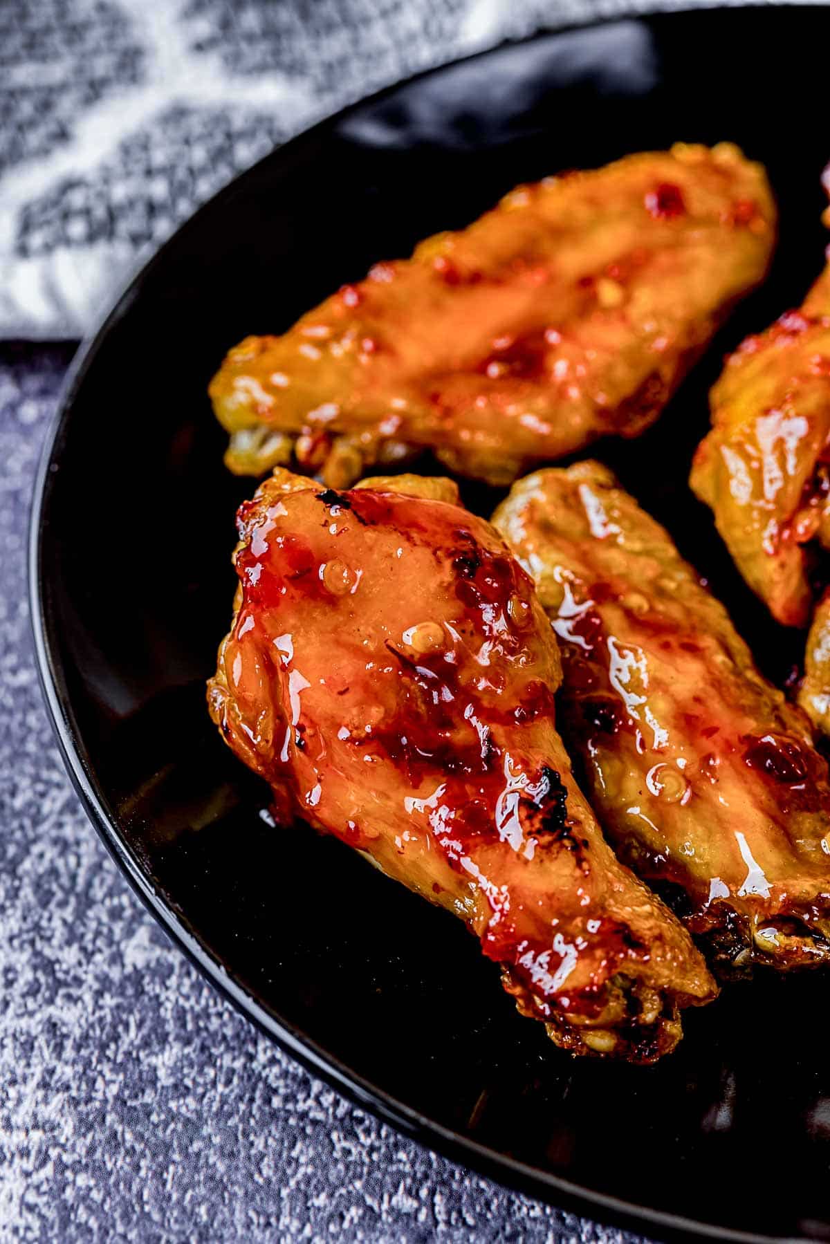 glazed chicken wings on a plate.