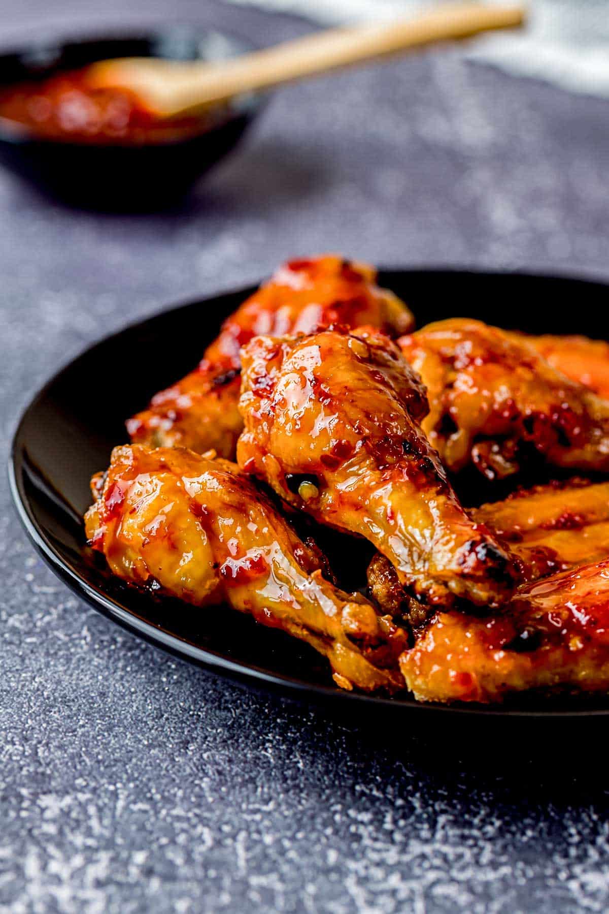 baked glazed garlic wings on a plate.