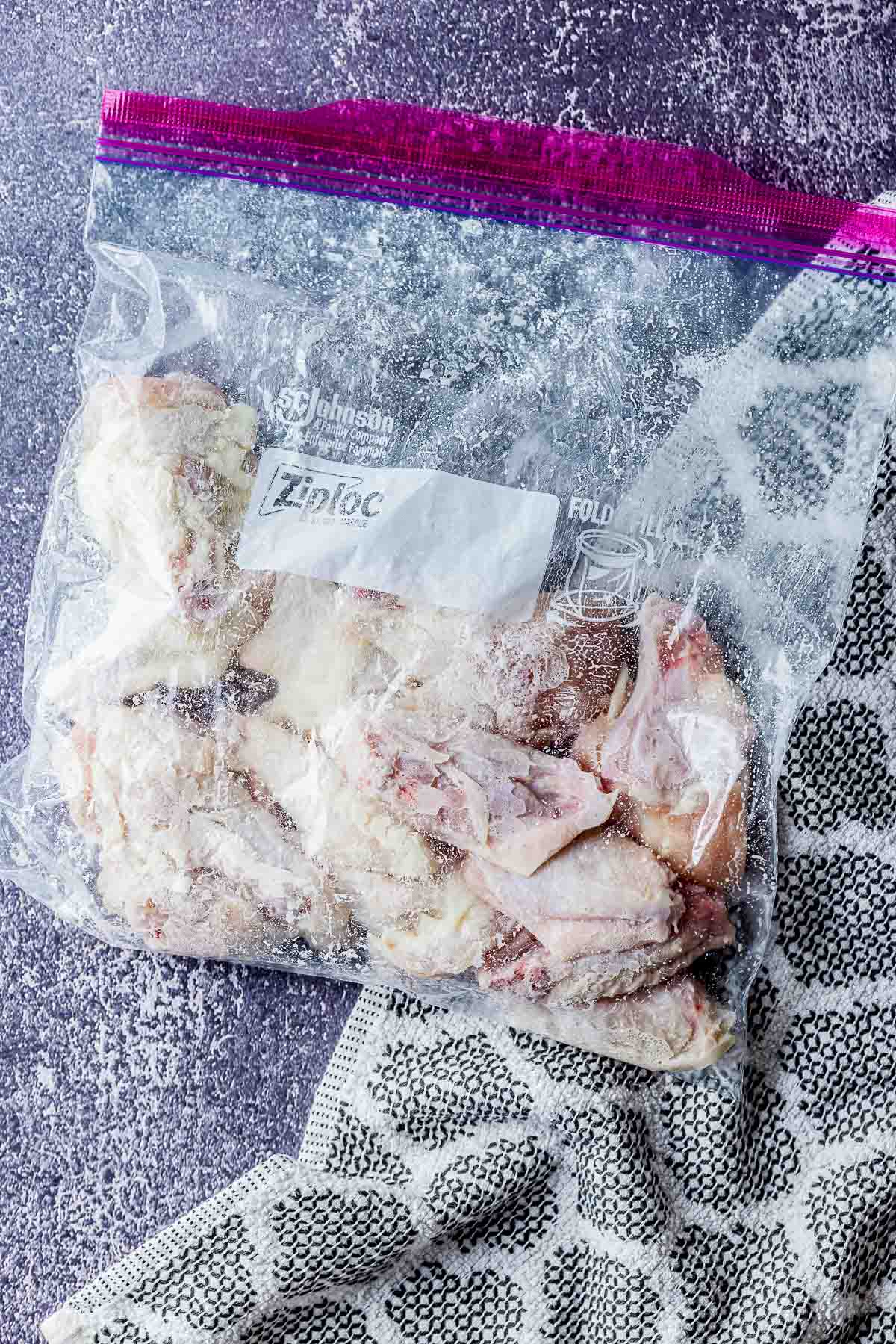 a bag of chicken wings coated in flour.