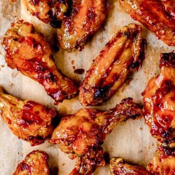 glazed wings on a wood board.