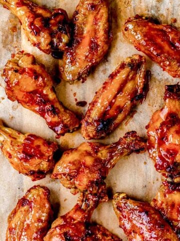 glazed wings on a wood board.