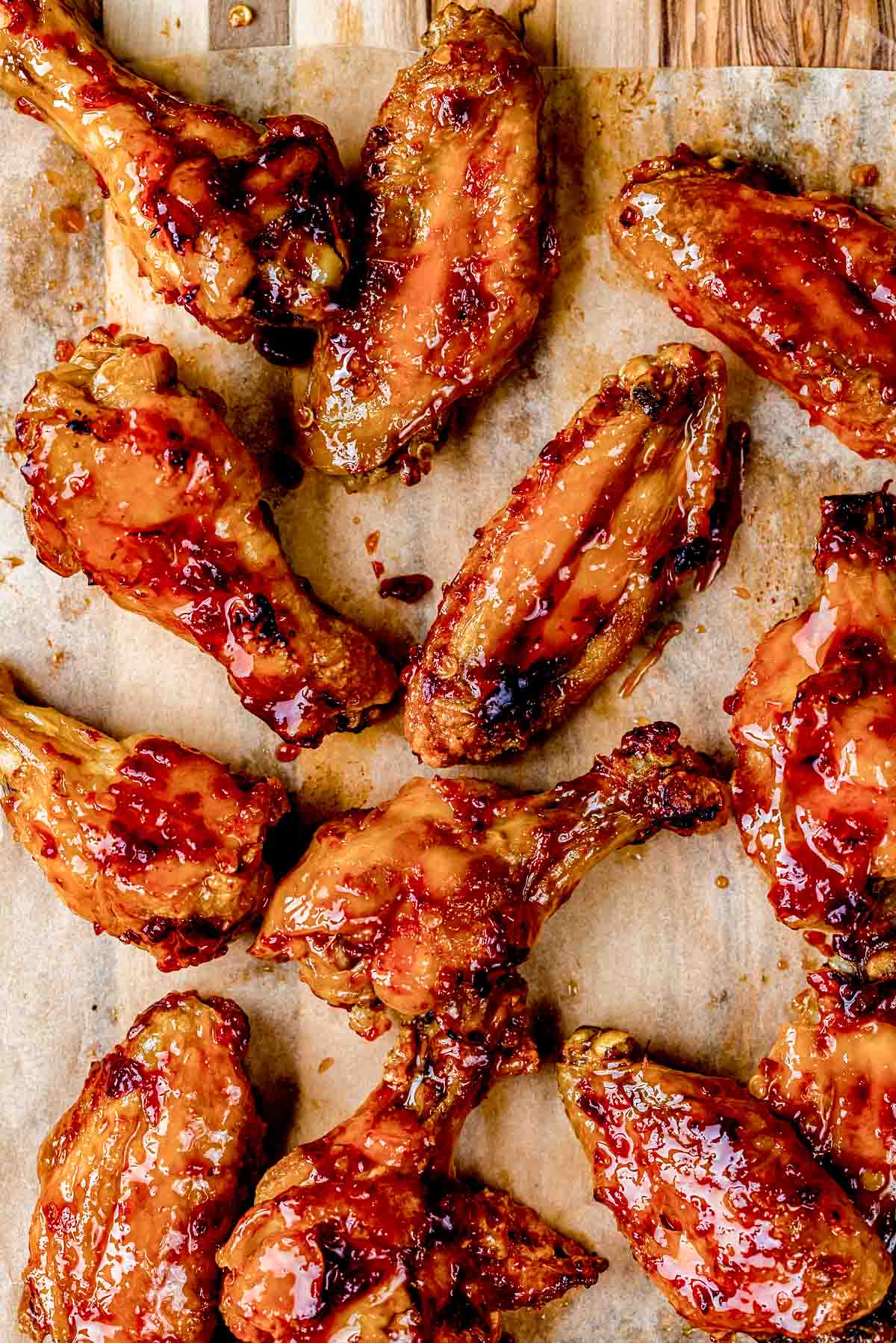 glazed wings on a wood board.