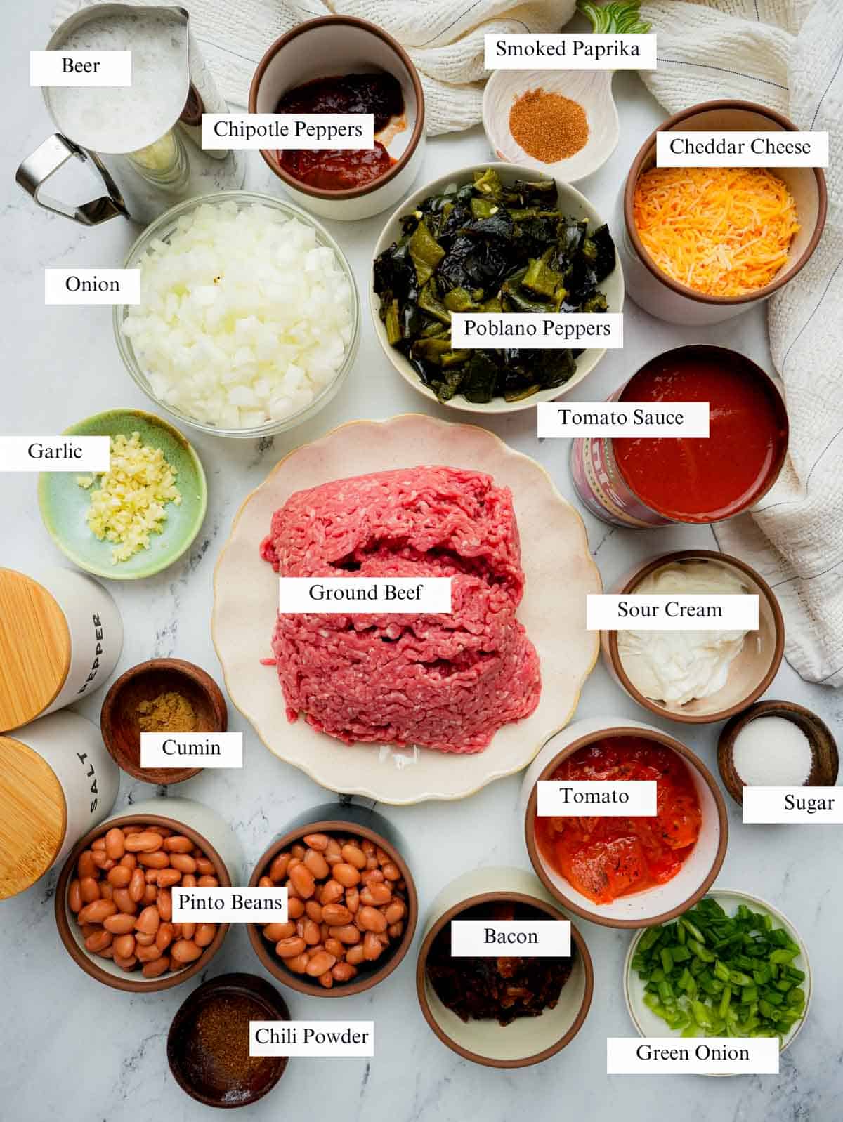 ingredients for instant pot beef and bean chili on a white surface with labels.