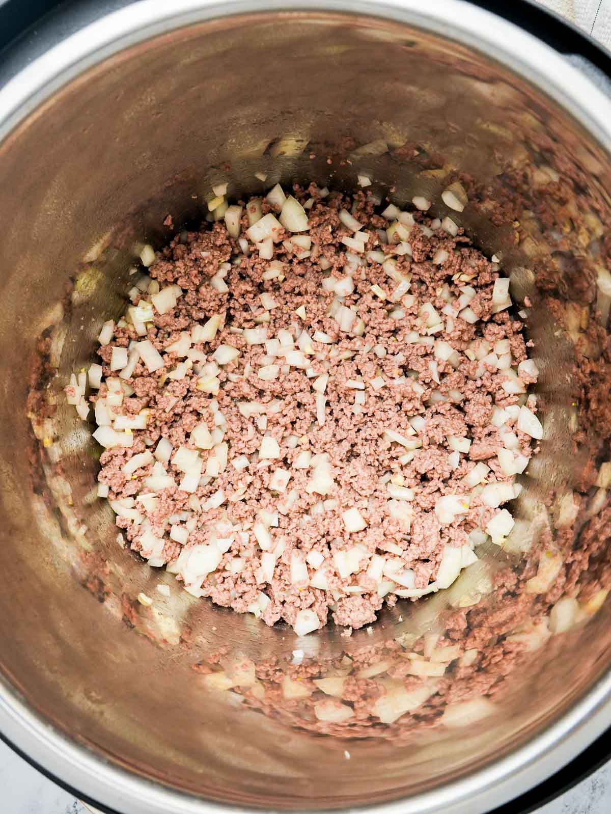 ground beef and onions in a pot.