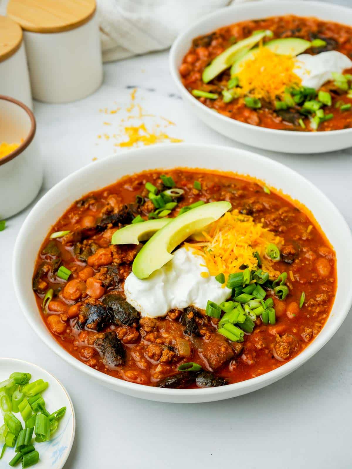 a bowl of chili with garnishes.