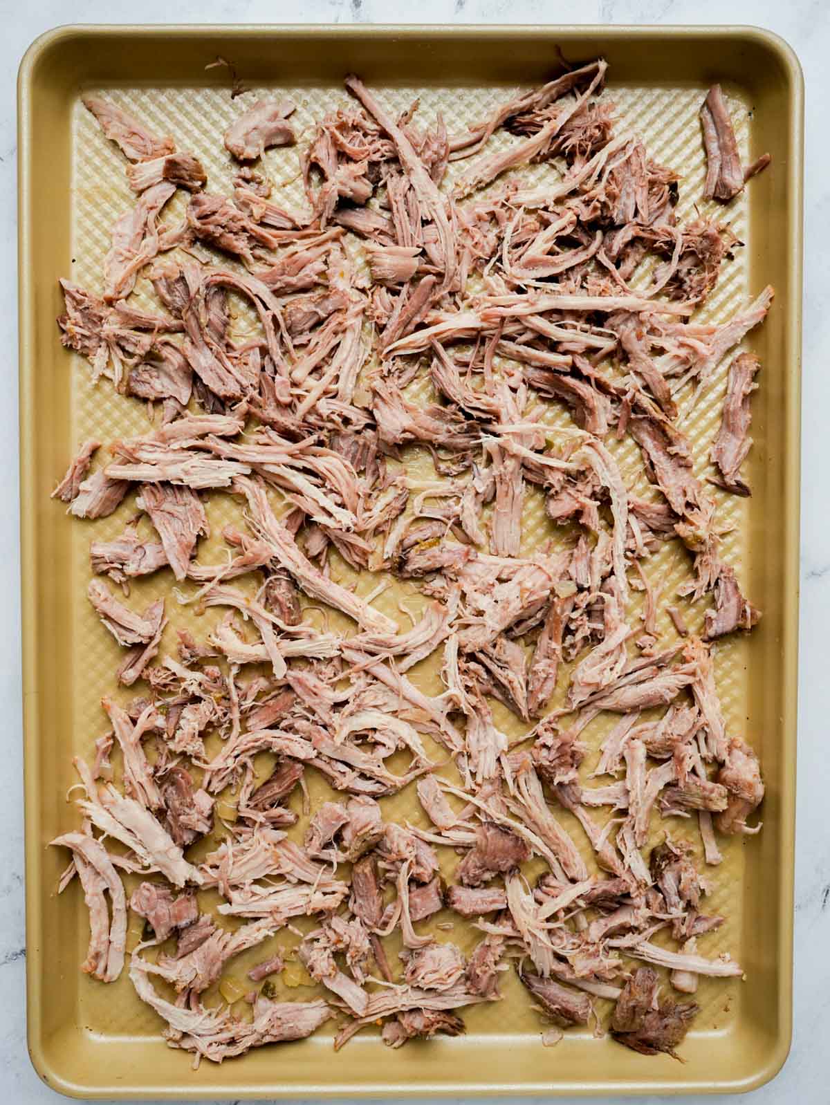 shredded pork on a baking sheet.