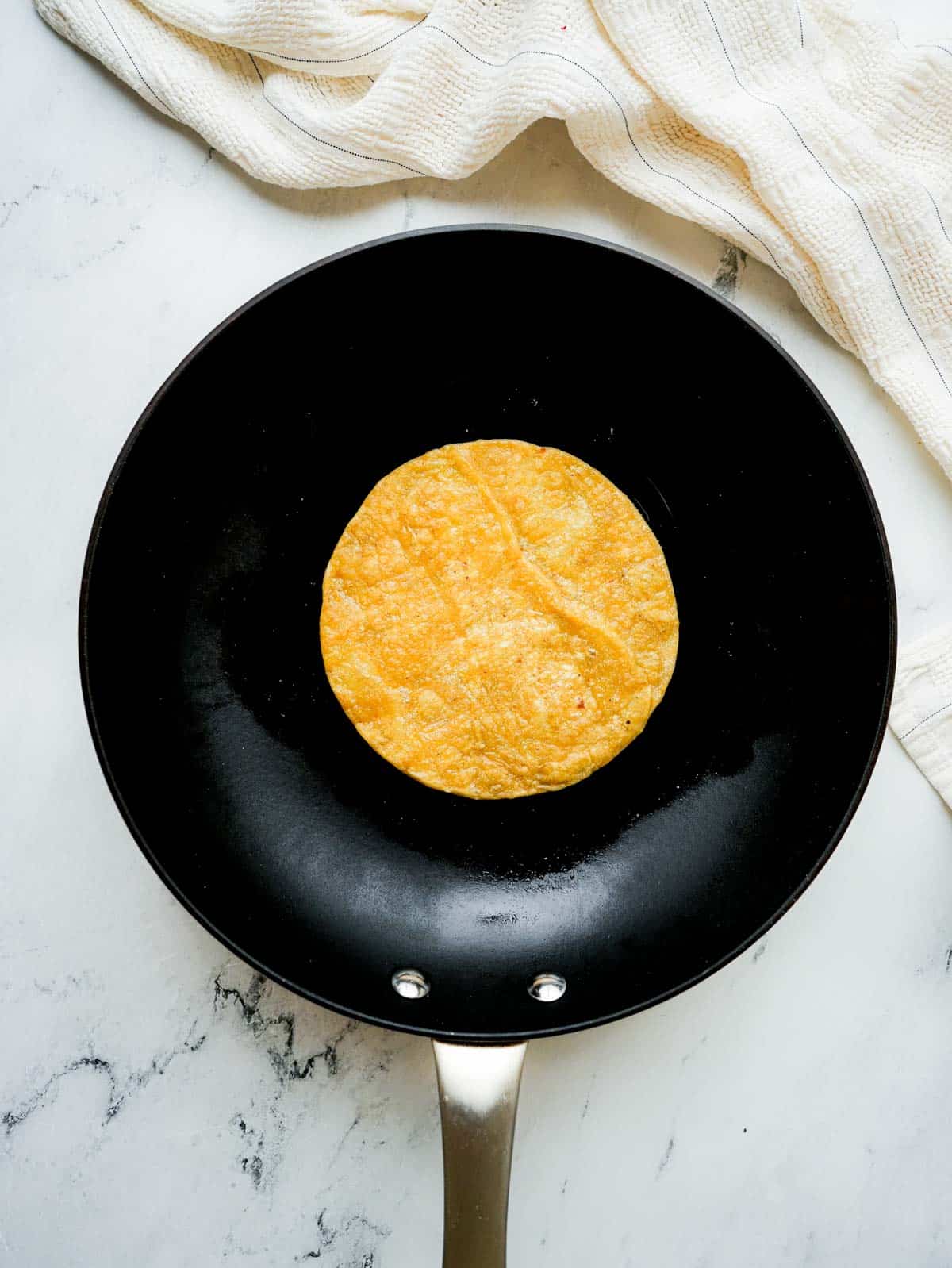 tortilla cooking in a skillet.