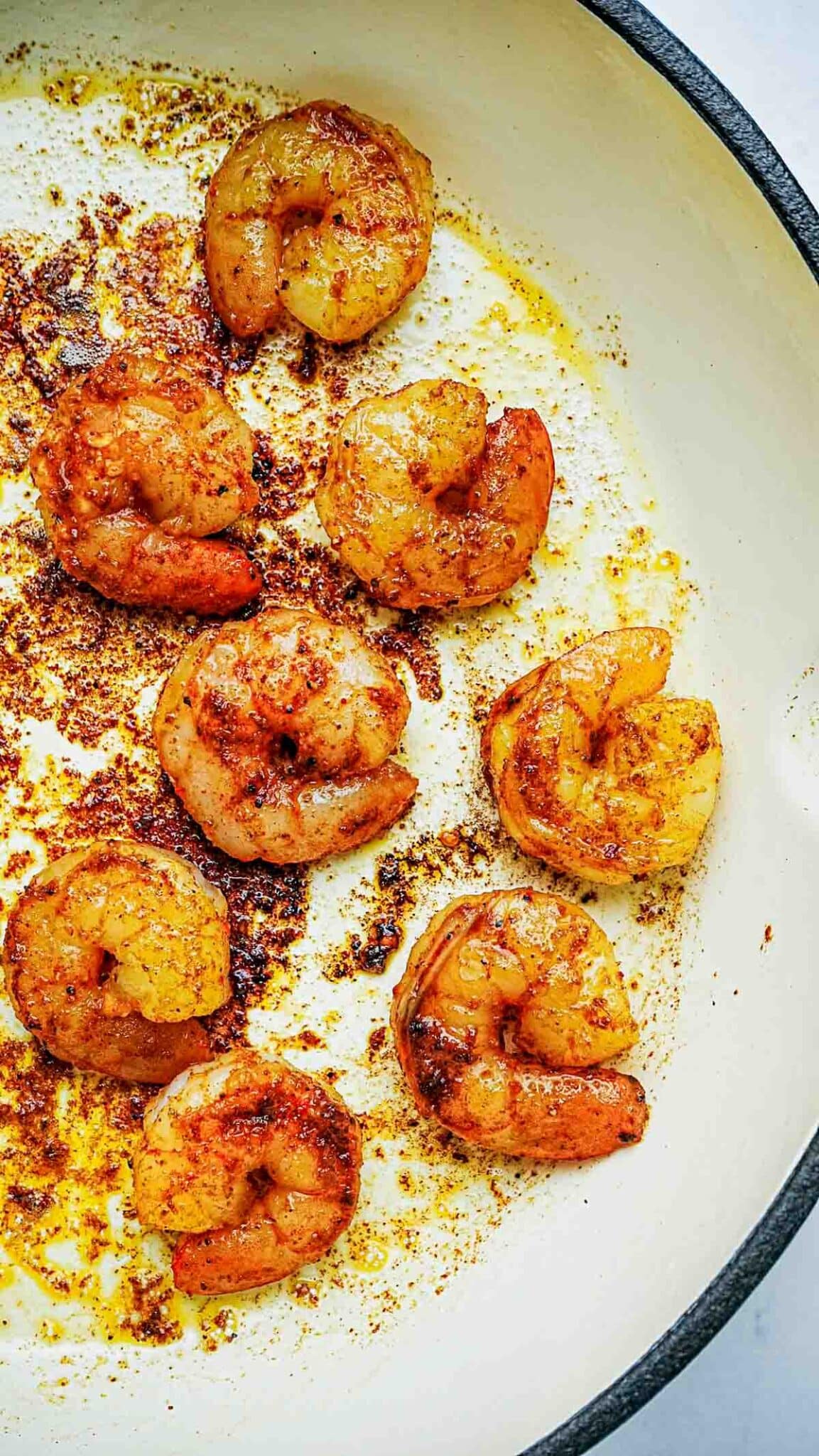 cooked, seasoned shrimp in a skillet.