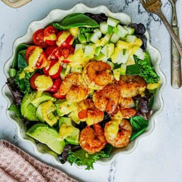 shrimp salad with avocado and yellow dressing.