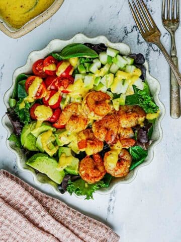 shrimp salad with avocado and yellow dressing.