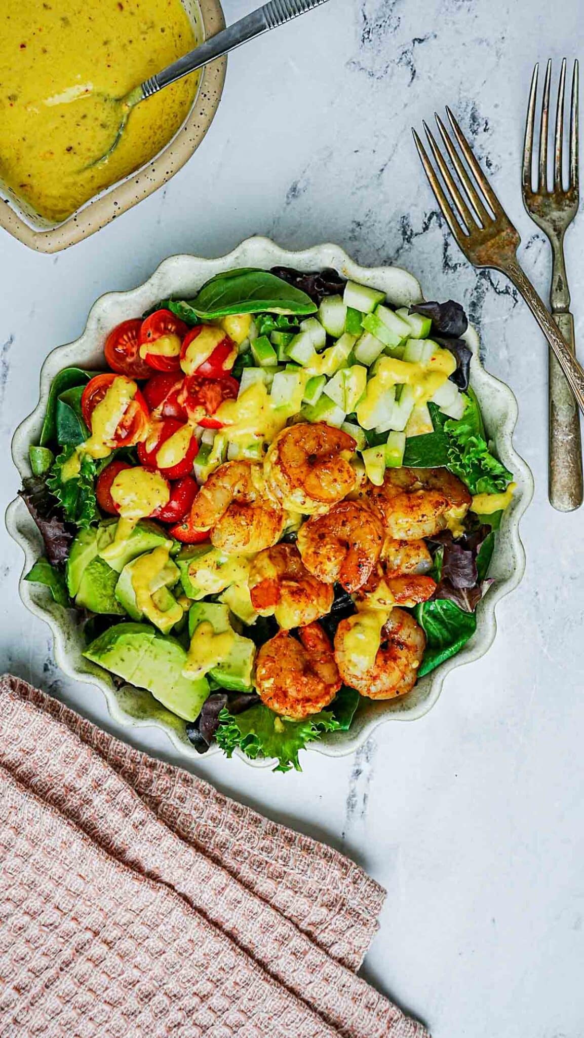 shrimp salad with avocado and yellow dressing.