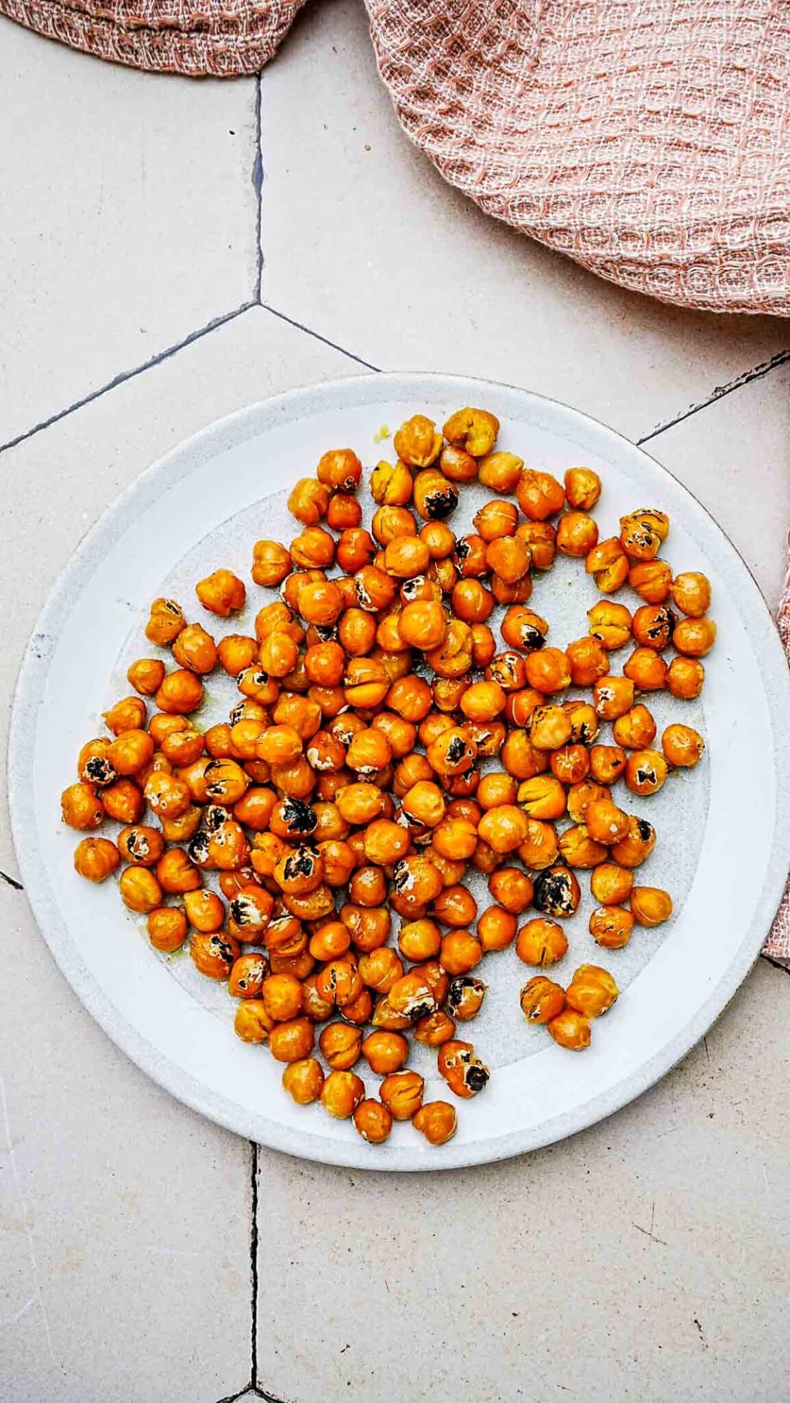 toasted chickpeas on a white plate.